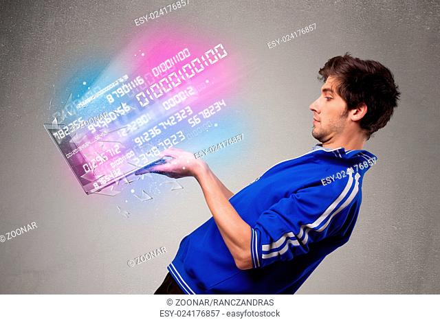 Casual man holding laptop with exploding data and numbers