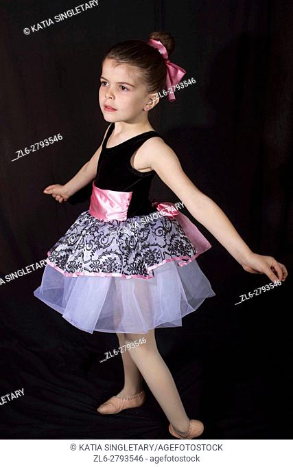 Little girl in her dancing outfits pose and have fun afront of the camera