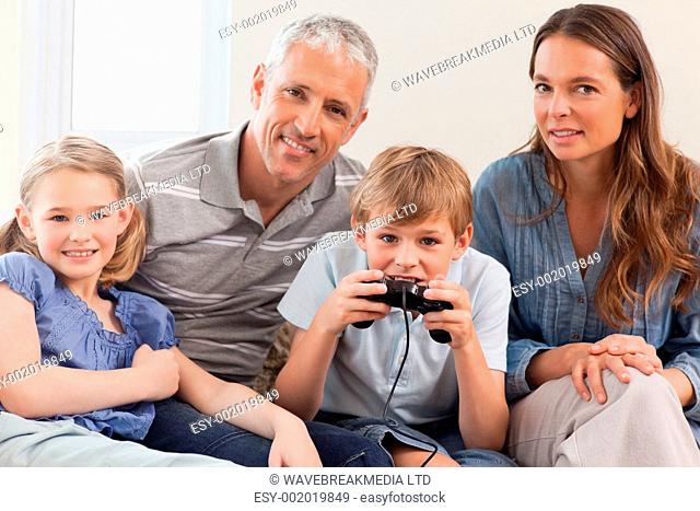 Charming family playing video games in a living room