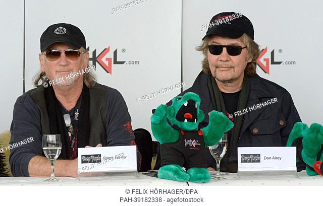 Bassist Roger Glover (L) Keyboardist Don Airey from British rock band Deep Purple takes a picture during a press conference for the Open Air Concert on the...