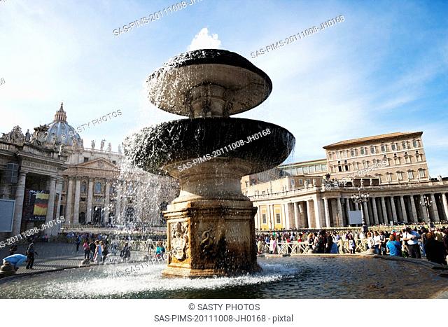 Fountain with a basilica in the background, St. Peters Basilica, St. Peters Square, Vatican City