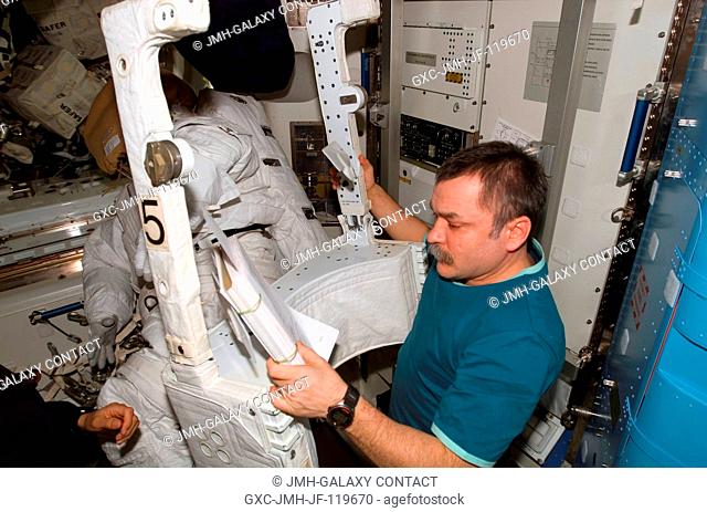 Cosmonaut Mikhail Tyurin, Expedition 14 flight engineer representing Russia's Federal Space Agency, looks over procedures checklists as he works with an...