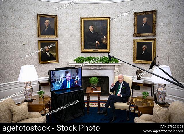 U.S. President Joe Biden, left, and Micheal Martin, Ireland's prime minister, right, meet virtually in the Oval Office of the White House in Washington, D
