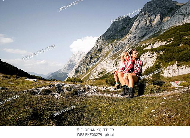 Austria, Tyrol, mother with daughter resting in mountainscape