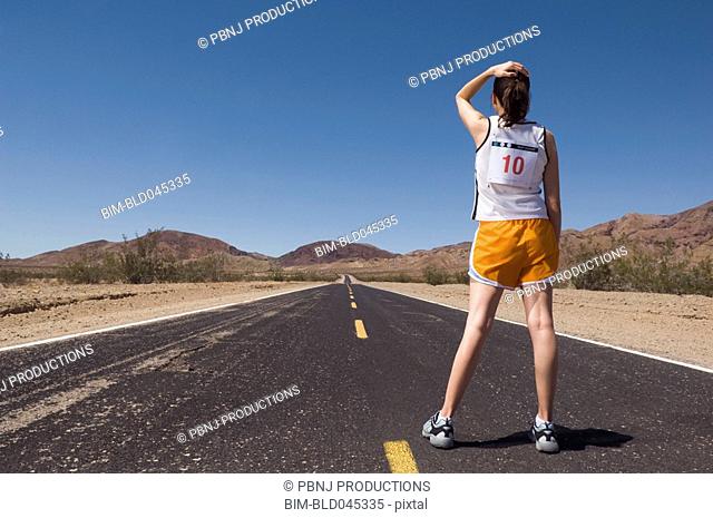 Mixed Race female runner on road