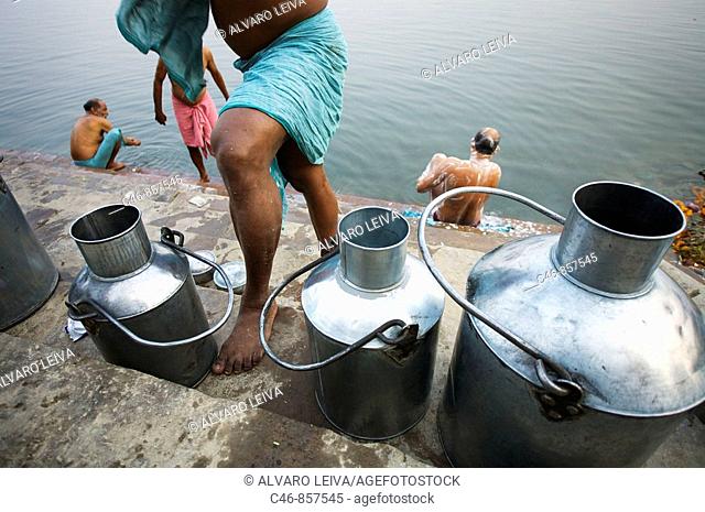 Milk cans on the ghats of Ganges river, Varanasi. Uttar Pradesh, India