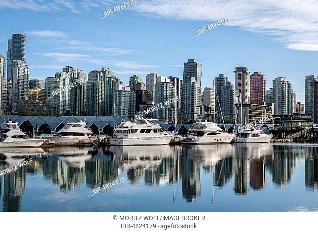 Skyscrapers and sailboats in the marina, skyline of Vancouver reflected in the sea, Coal Harbour, Downton Vancouver, British Columbia, Canada