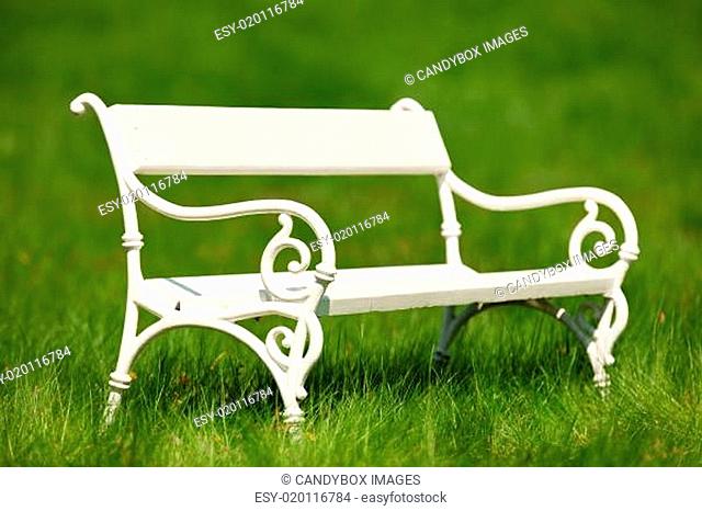 Spring and summer - White romantic bench in meadow