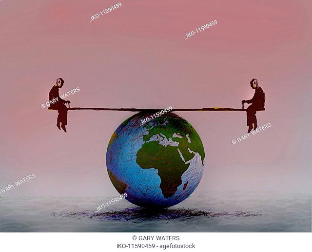 Men balanced on seesaw over globe