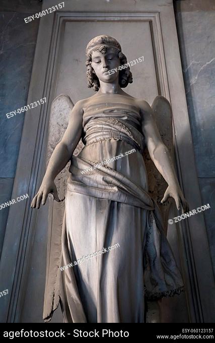 GENOA, ITALY - June 2020: antique statue of angel (beginning 1900, marble) in a Christian Catholic cemetery - Italy