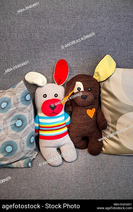 funny, homemade cuddly toys on a sofa, teddy bear
