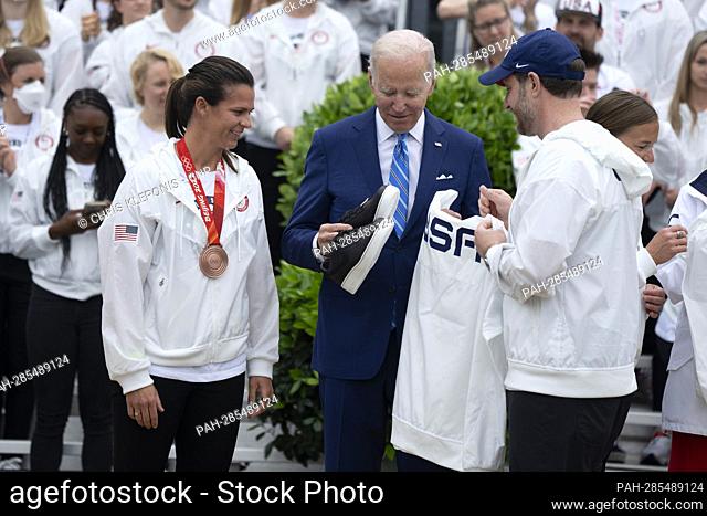 United States President Joe Biden receives gifts from members of Team USA during a ceremony celebrating their participation in the Tokyo 2020 Summer Olympic and...