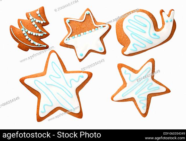 Christmas gingerbreads isolated on white background. Cookies in shape of stars, christmas tree and snail. Top view