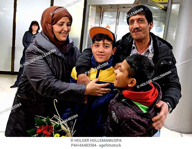 Afghan refugee boy Mahdi Rabani (C) stands next to his mother Shockria, his father Ibrahim (R) and his brother Yussuf in the arrivals hall of the...