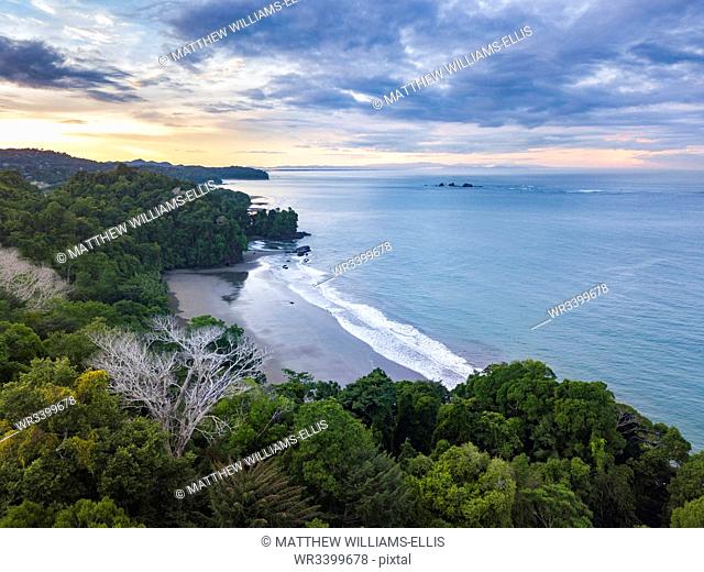 Drone view of Arco Beach and rainforest at sunrise, Uvita, Puntarenas Province, Pacific Coast of Costa Rica, Central America