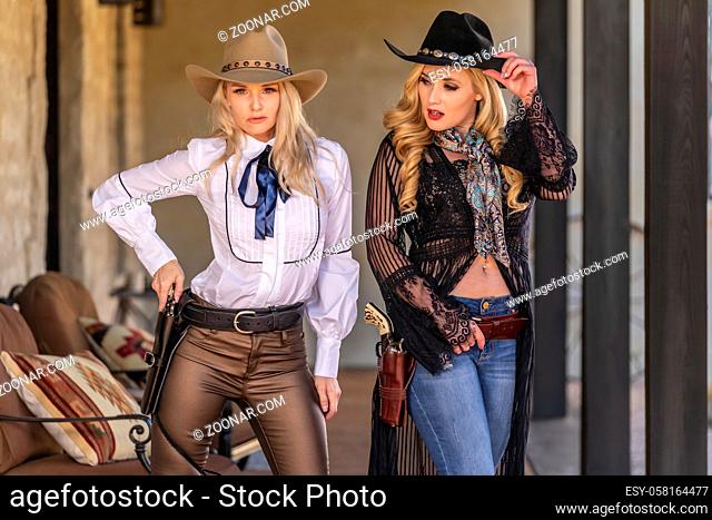 Two gorgeous blonde models dressed as cowgirls enjoying the outdoor weather