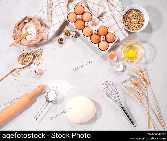 Top view of dough ingredients on kitchen table isolated on grey backround home-bakery concept
