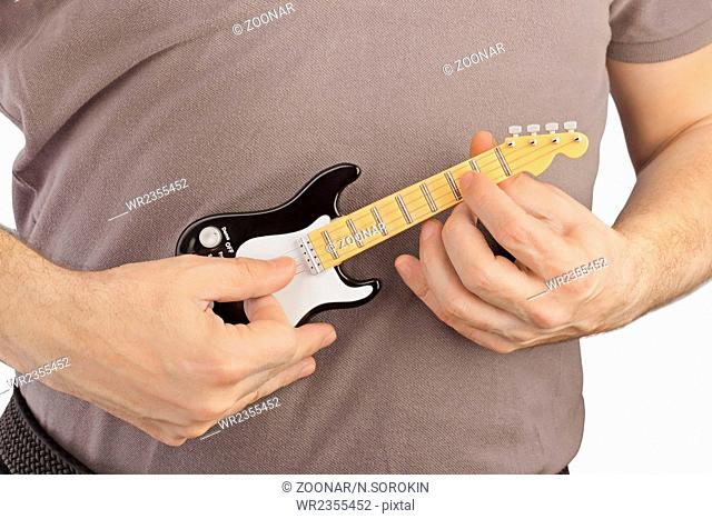 Hands and toy electric guitar