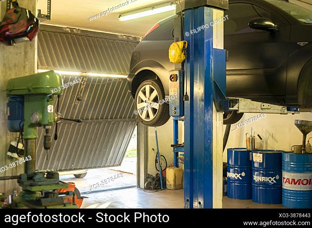 MILAN, ITALY: Interior of a garage with a car during repairing