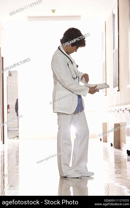 Female doctor looking through her notes