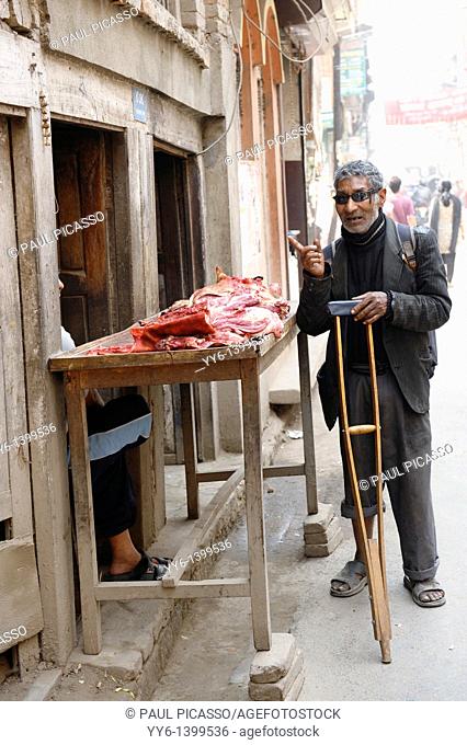 disabled blind man buying meat from street butcher , the nepalis , life in kathmandu , kathmandu street life , Nepal