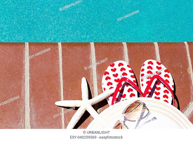 Colorful flip flops by a swimming pool