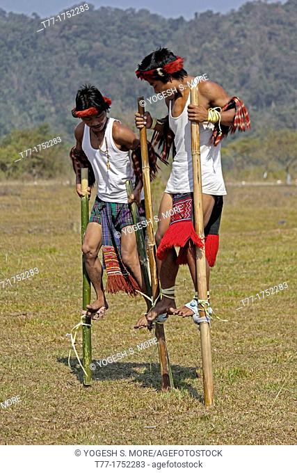 Nocte warrior tribes, playing bamboo stilts game at Namdapha Eco Cultural Festival, Miao, Arunachal Pradesh, India