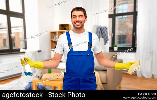 male cleaner with rag and detergent cleaning home