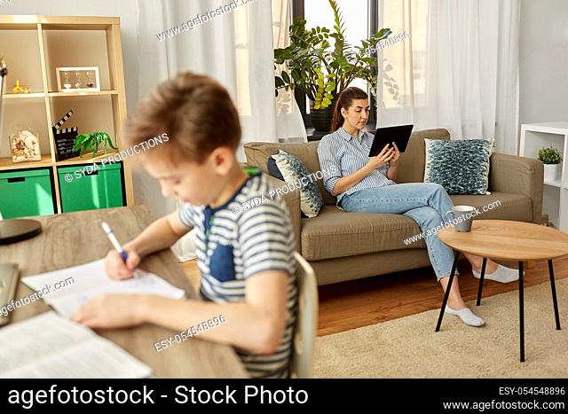 mother with tablet pc and son learning at home