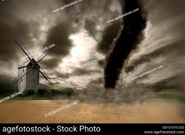 Zoom of a Large tornado over a wind mill