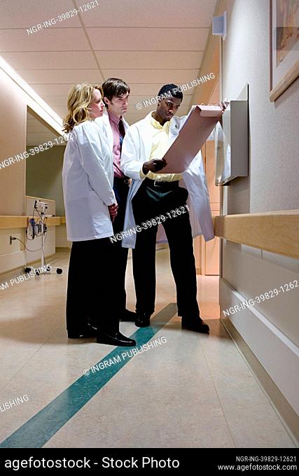Doctors looking at patient notes
