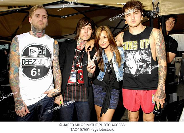 (L-R) Jona Weinhofen and Oliver Sykes of Bring Me The Horizon, Demi Lovato and guest at the Vans Warped Tour 2010 at Seaside Park on June 27, 2010 in Ventura