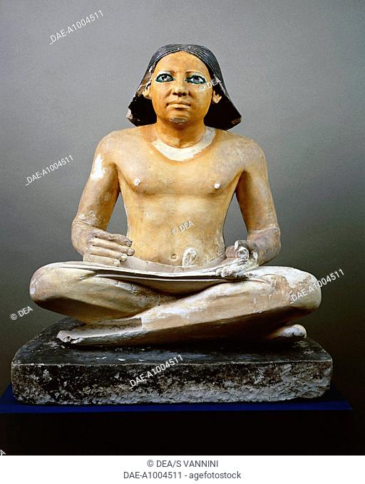 Egyptian civilization, Old Kingdom, Dynasty V. Statue of a seated scribe with papyrus, 2475 b.C. circa. Painted limestone. From Saqqara