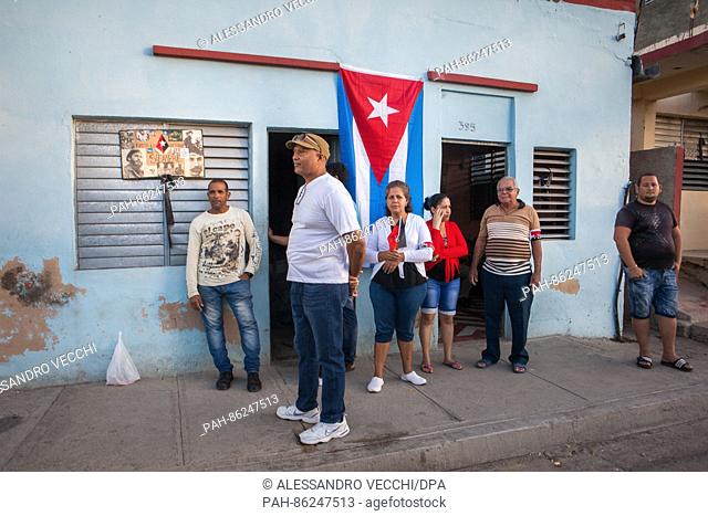 Santiago de Cuba, Cuba - 04.12.2016. People are hanging in front of their houses minutes after watching Castro's ashes passing on their way from Plaza Maceo...