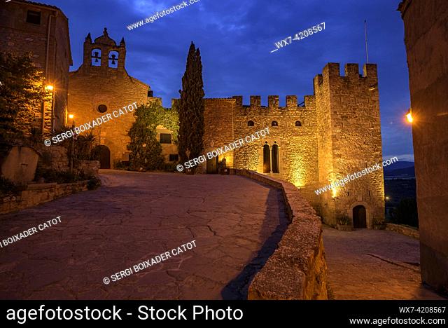 Montsonís Castle and Santa Maria church illuminated at night and at blue hour (La Noguera, Lleida, Catalonia, Spain)