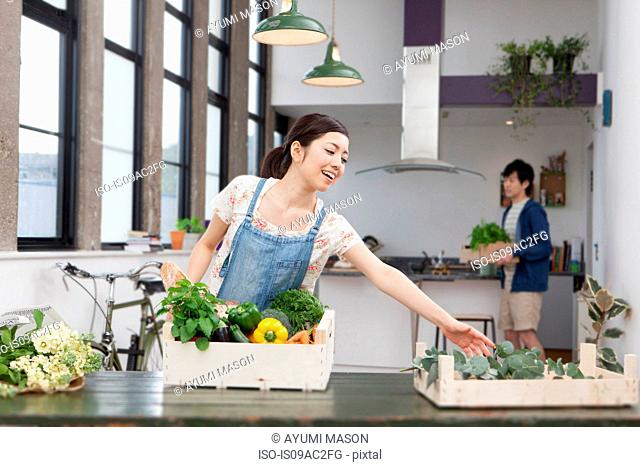 Young couple in kitchen preparing fresh food