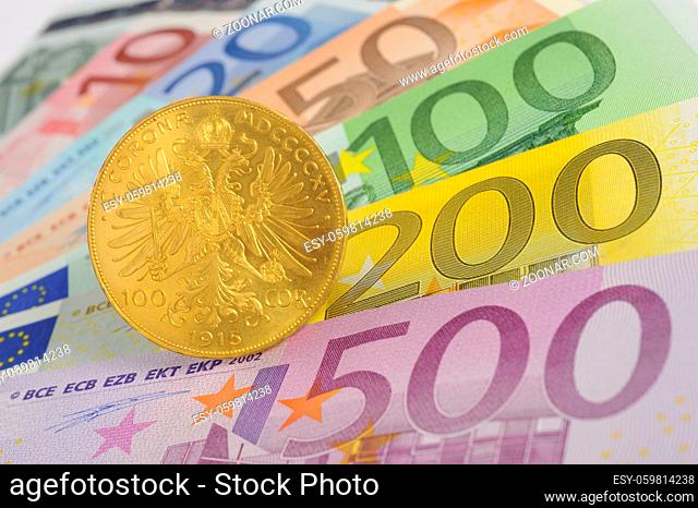 gold coin and euro banknotes