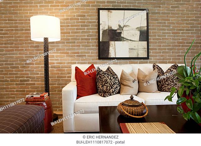 Contemporary living room with brick wall at home