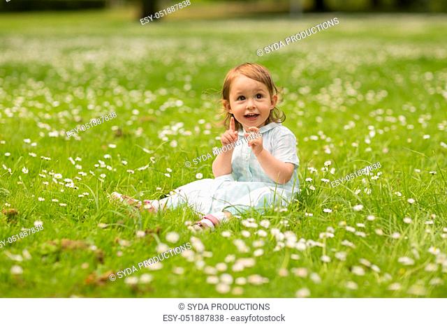 happy little baby girl at park in summer