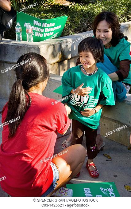 A Hispanic child dons a green 'solidarity' t-shirt at a rally supporting the American Federation of State, County and Municipal Workers AFSCME labor union in...