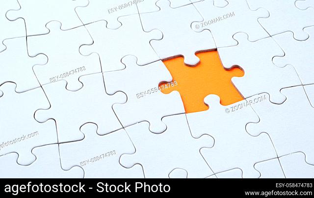 Empty white jigsaw puzzle with missing piece