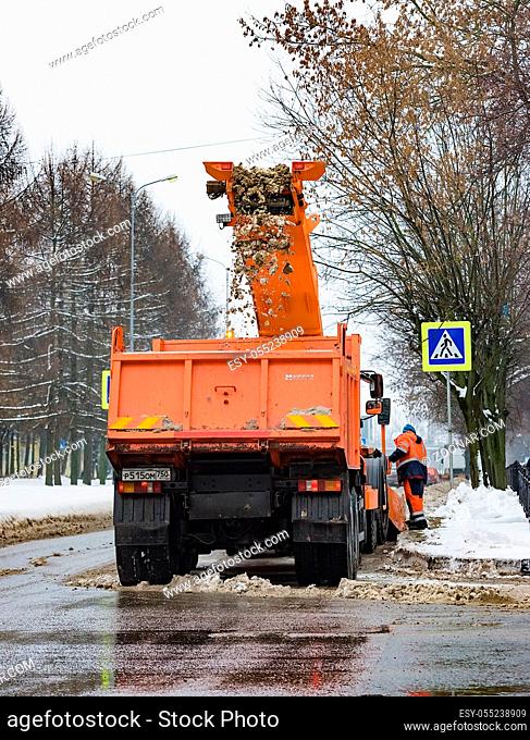 Russia. Chekhov. February 16, 2019.Tractor loads snow into the truck. City services snow removal special equipment after snowfall. urban utilities
