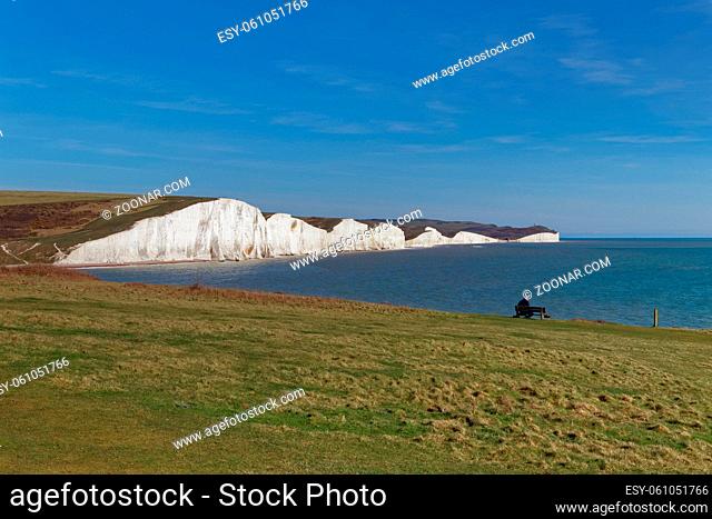 SEAFORD, SUSSEX/UK - APRIL 5 : Man Sitting on a Bench overlooking the Seven Sisters near Seaford in Sussex on April 5, 2018. Unidentified Man