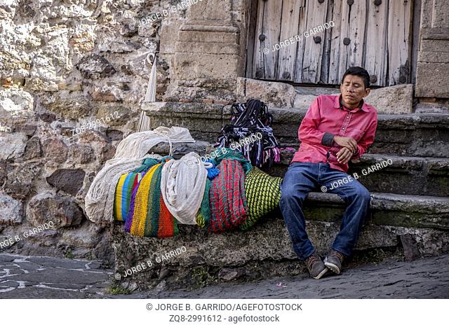 A vendor sells souvenirs for tourists in front of a colonial home in Taxco de Alarcon, Guerrero State, Mexico