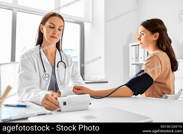 female doctor with tonometer and patient at clinic