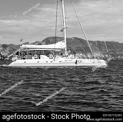 from  boat  in europe greece santorini island house and rocks the sky