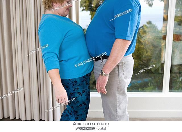 Overweight couple touching bellies