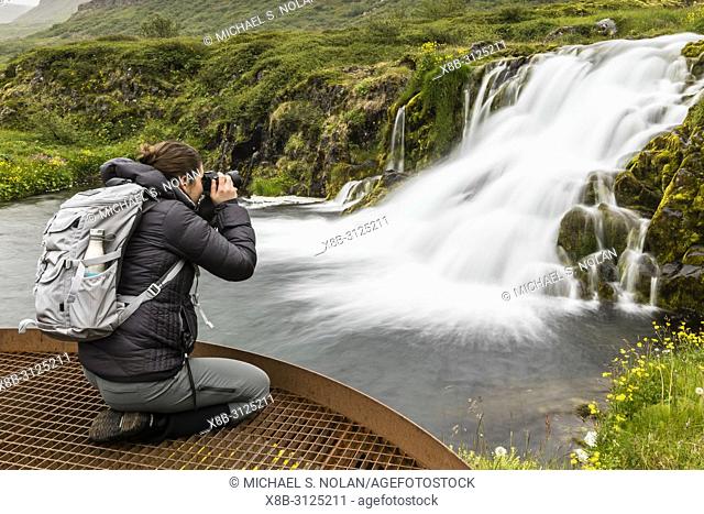 Photographer at Dynjandi, Fjallfoss, a series of waterfalls located in the Westfjords, Iceland