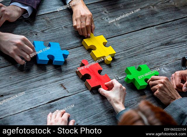 Business teamwork with color puzzle of four pieces cooperation unity concept