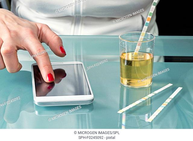Testing urine with reagent paper while using healthcare application on smart phone